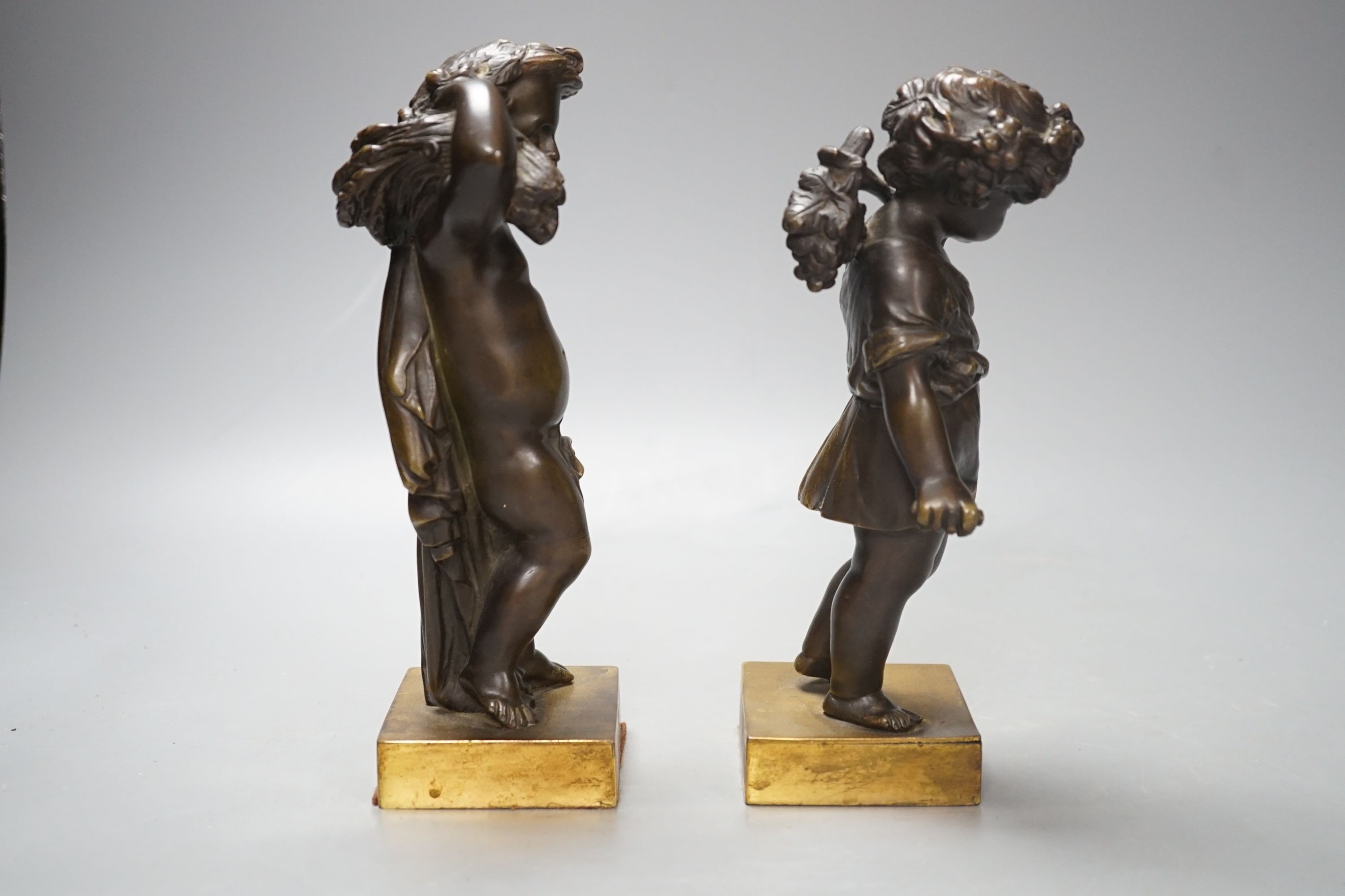 A pair of late 19th century bronze cherubs, emblematic of the seasons, Summer and Autumn, 21cm high